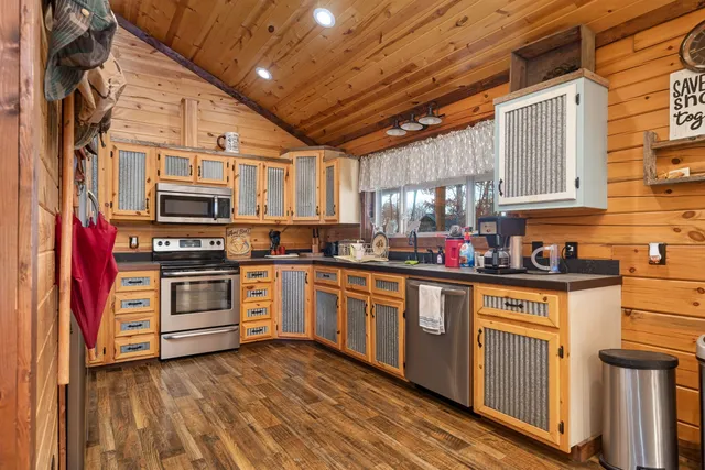 a kitchen with stainless steel appliances granite countertop a stove and a sink