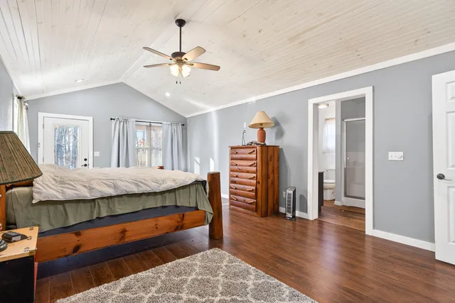 a bathroom with a sink a toilet a mirror and shower