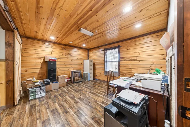 a view of a hallway with wooden floor and entryway
