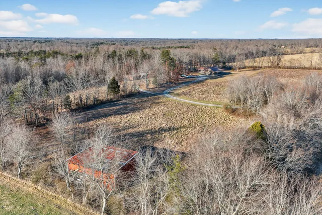 a view of a yard with wooden fence