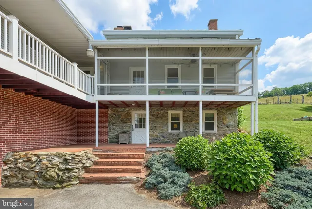 a view of a big yard with a house in the background