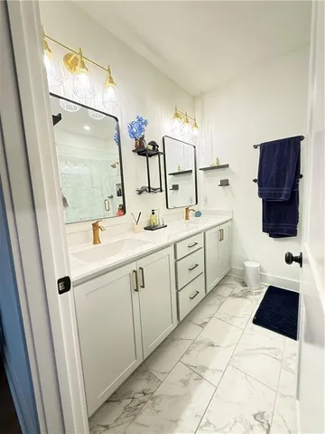 a bathroom with a sink a toilet and mirror