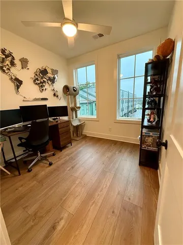 a view of a workspace with furniture and a window