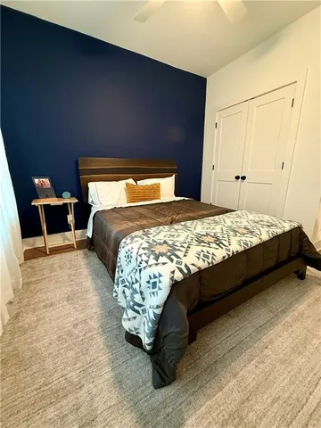 a bed sitting in a bedroom next to a window