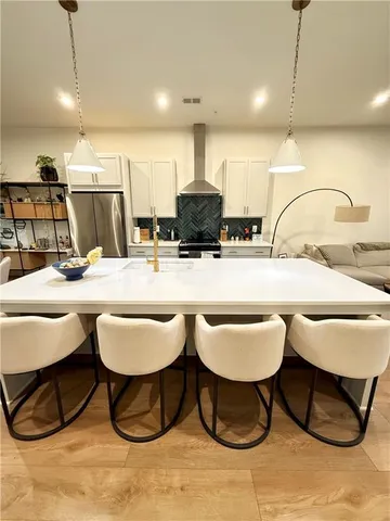 a kitchen with a sink and chairs