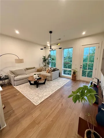 a living room with furniture fireplace and a large window