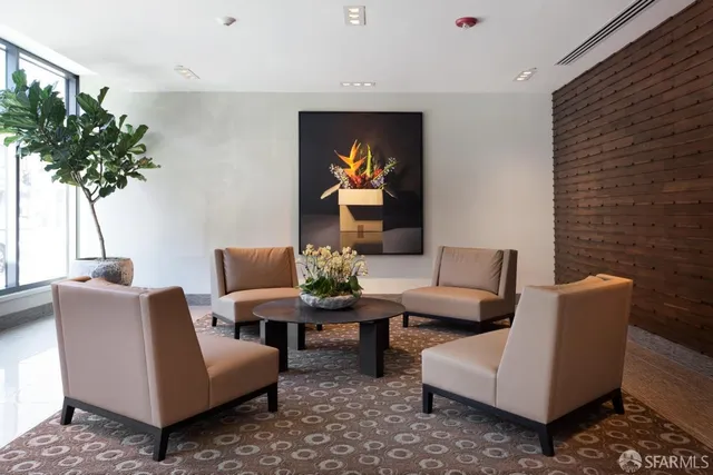a living room with furniture and a potted plant
