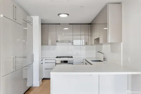 a kitchen with a refrigerator a stove and a sink