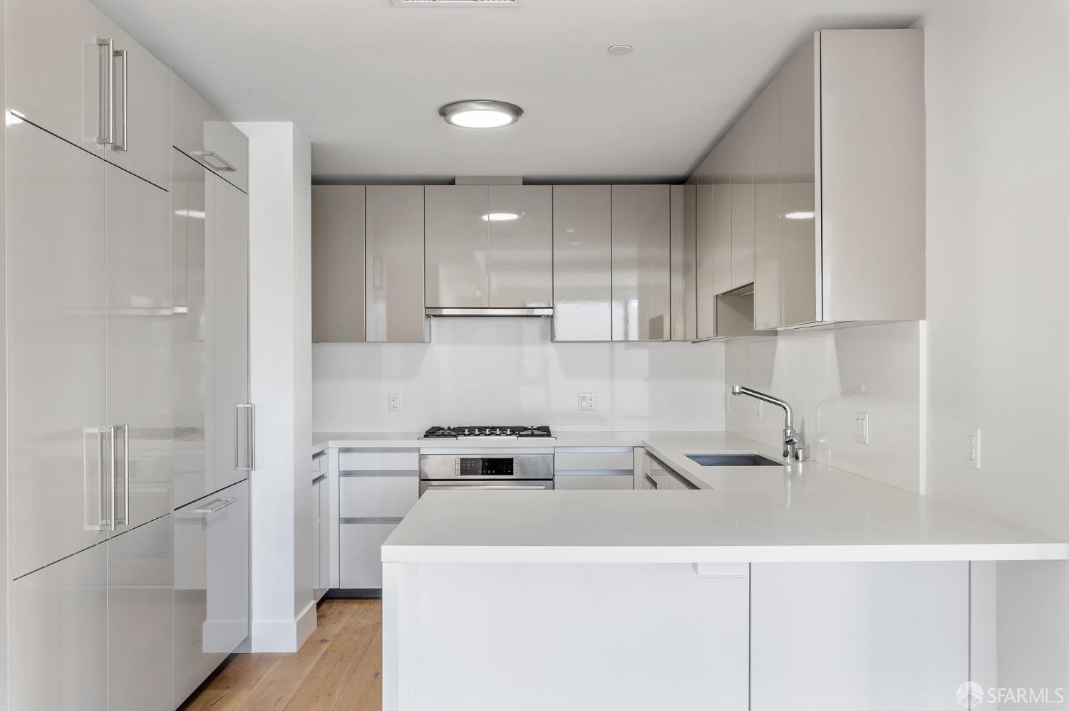 1450 Franklin Street, Unit 701 San Francisco, CA 94109 - Photo 3 of 20 a kitchen with a refrigerator a stove and a sink