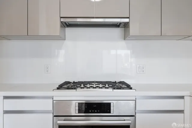 a stove top oven sitting inside of a kitchen