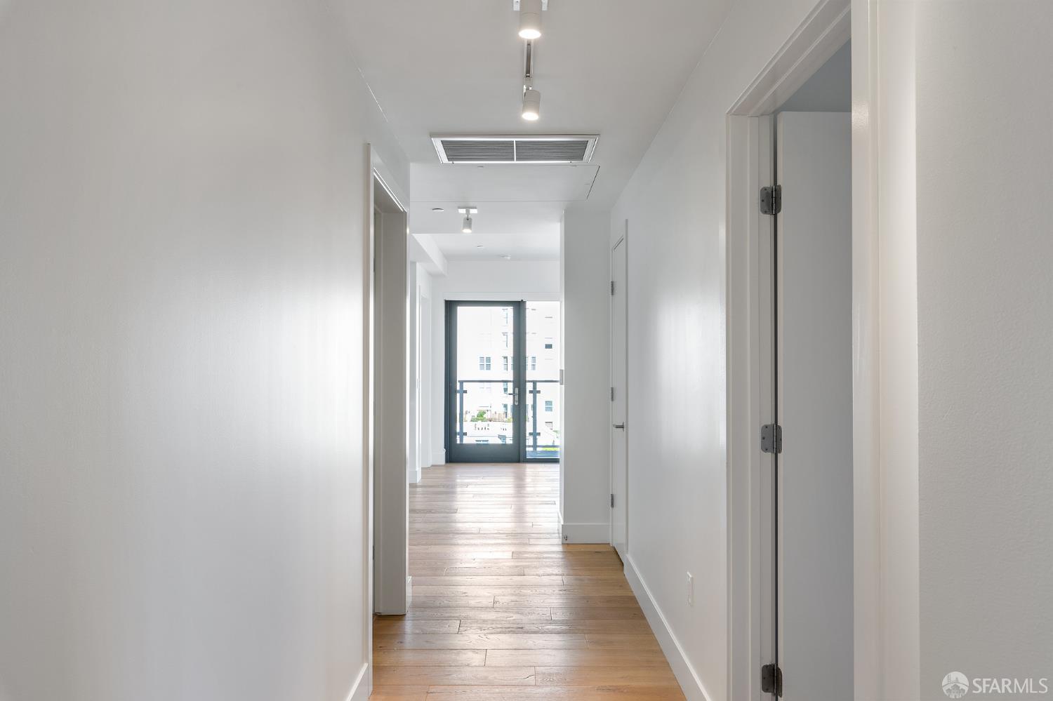 1450 Franklin Street, Unit 701 San Francisco, CA 94109 - Photo 7 of 20 a view of a hallway with wooden floor and closet
