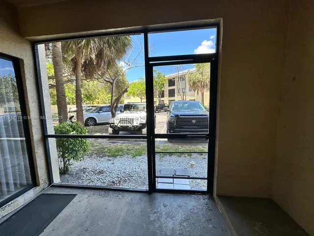 a view of a glass door and a window