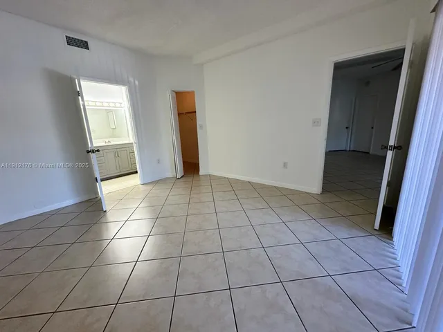 a view of a livingroom with an empty space and a window