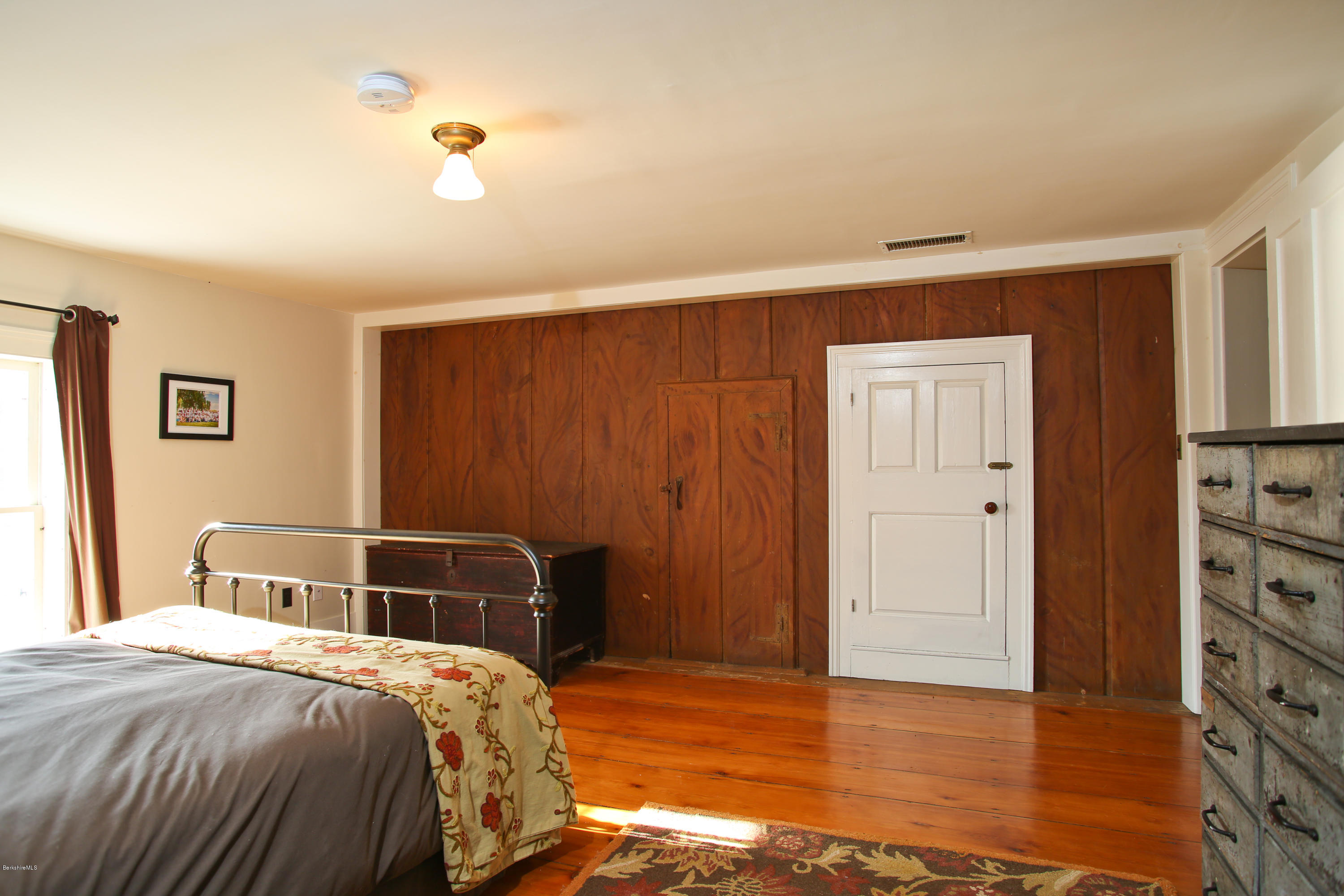 4105 Hancock Road Hancock, MA 01237 - Photo 41 of 57 a bedroom with a bed and wooden floor