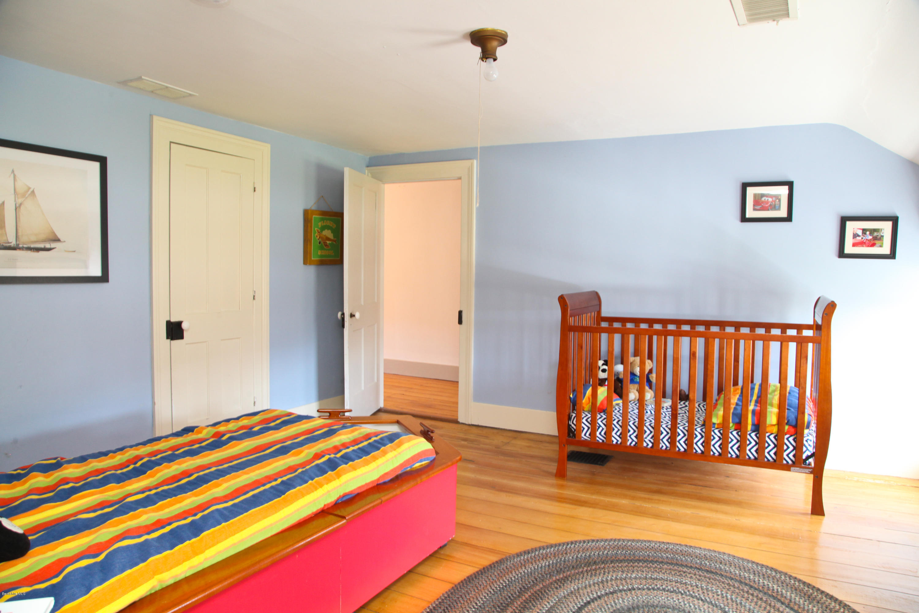 4105 Hancock Road Hancock, MA 01237 - Photo 48 of 57 a bedroom with a bed and wooden floor