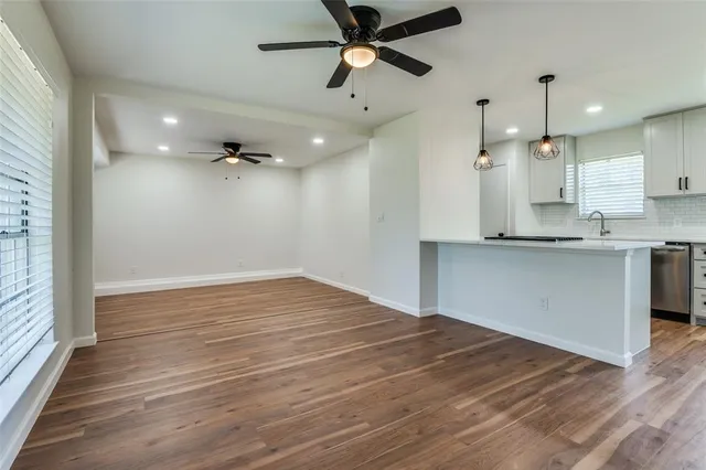 a view of a kitchen with a sink and a refrigerator