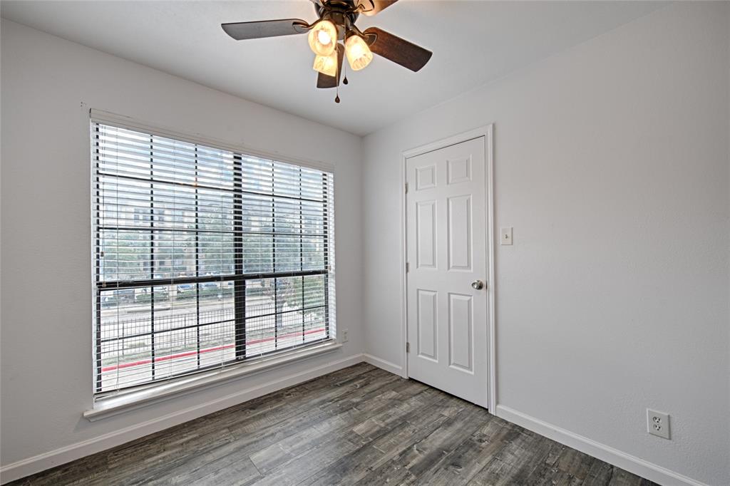8545 Midpark Road, Unit 2 Dallas, TX 75240 - Photo 13 of 19 a view of an empty room with wooden floor and a window