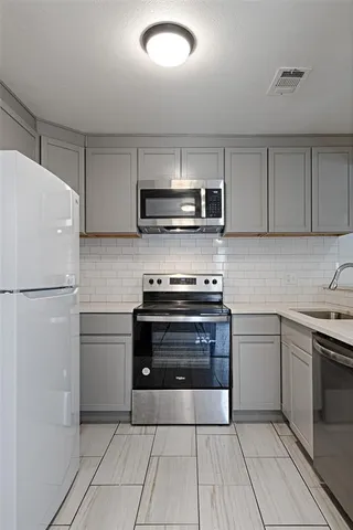 a kitchen with a refrigerator stove and microwave