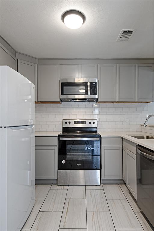8545 Midpark Road, Unit 2 Dallas, TX 75240 - Photo 5 of 19 a kitchen with a refrigerator stove and microwave