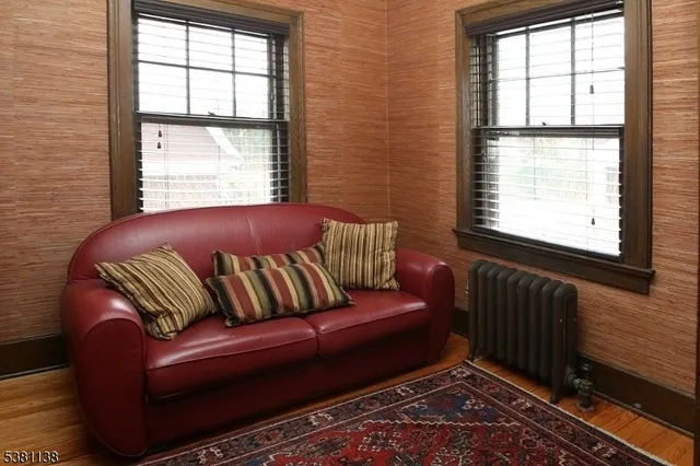 a blue couch sitting in a living room next to a window