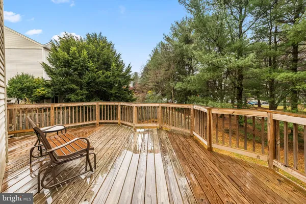 a balcony with wooden floor and fence