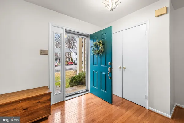 a living room with furniture a wooden floor and next to a window