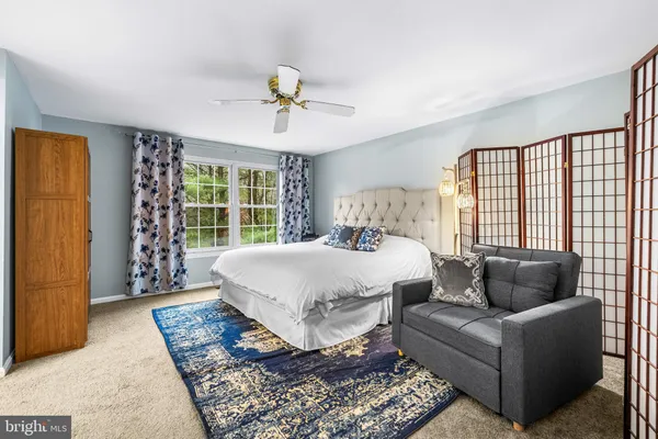 a bedroom with a bed and chandelier