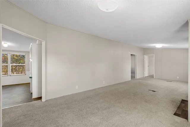 a view of a kitchen with wooden floor and a window