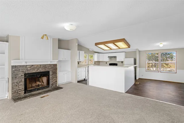 a view of a big room with windows and chandelier