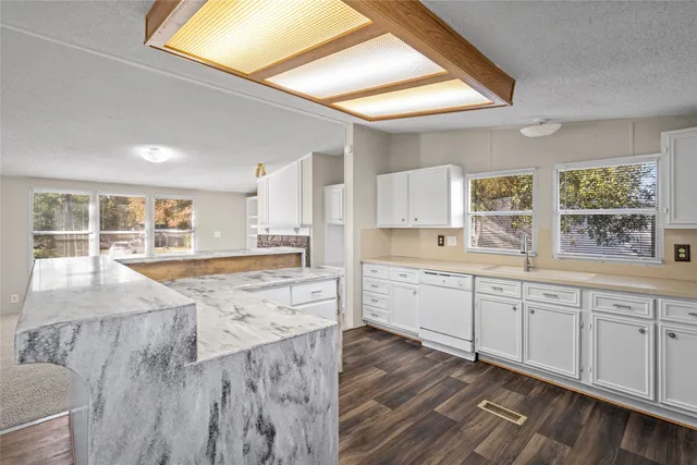 a kitchen with cabinets appliances and a window