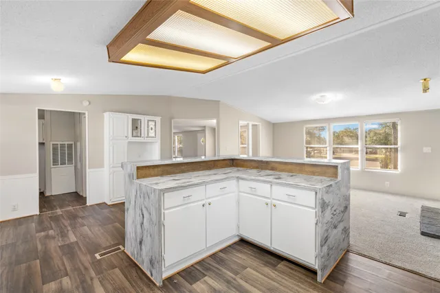 a large kitchen with stainless steel appliances granite countertop a stove a sink and a refrigerator