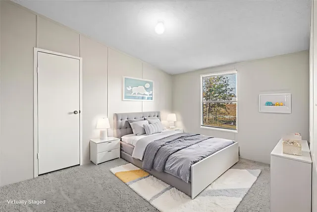 a bathroom with a granite countertop bathtub shower sink vanity mirror and toilet