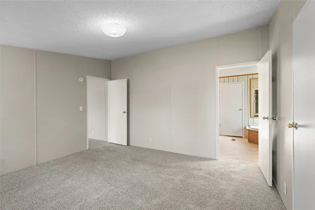 a bathroom with a tub a sink and a large window