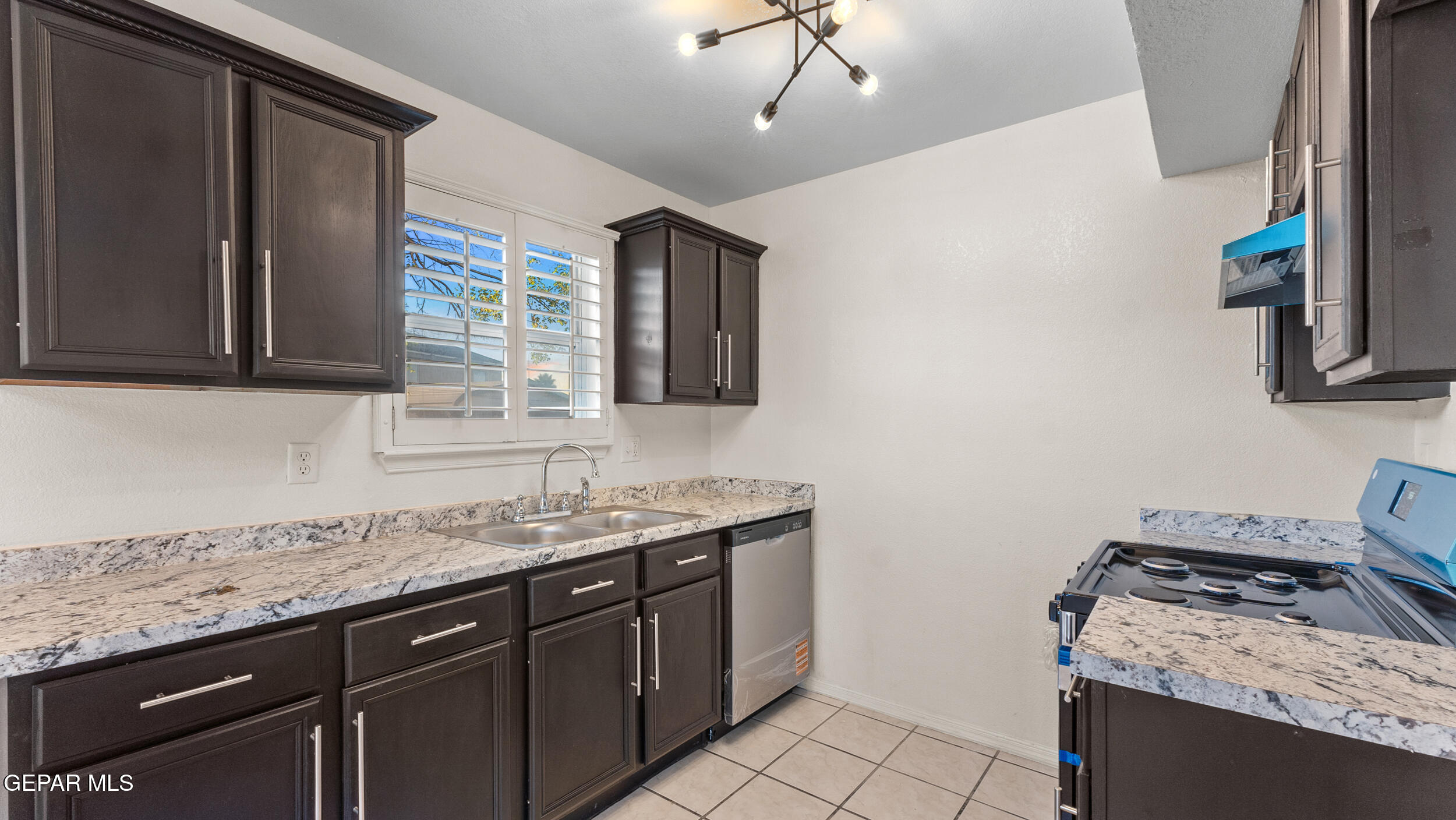 1729 St Mark Avenue El Paso, TX 79936 - Photo 11 of 31 a kitchen with a sink stove and cabinets