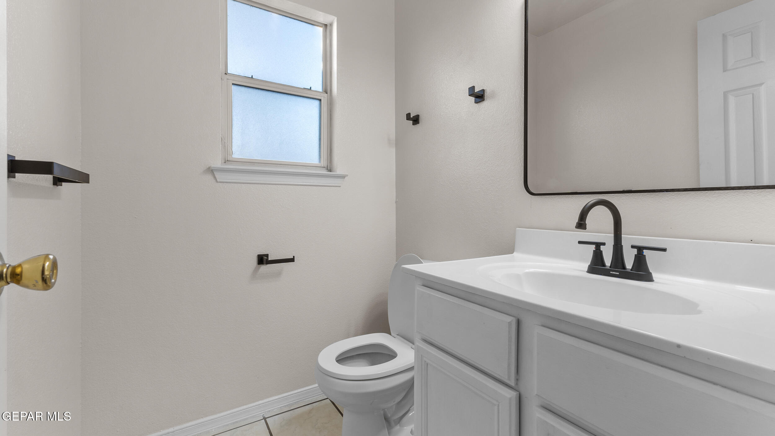 1729 St Mark Avenue El Paso, TX 79936 - Photo 13 of 31 a bathroom with a sink a toilet and a mirror