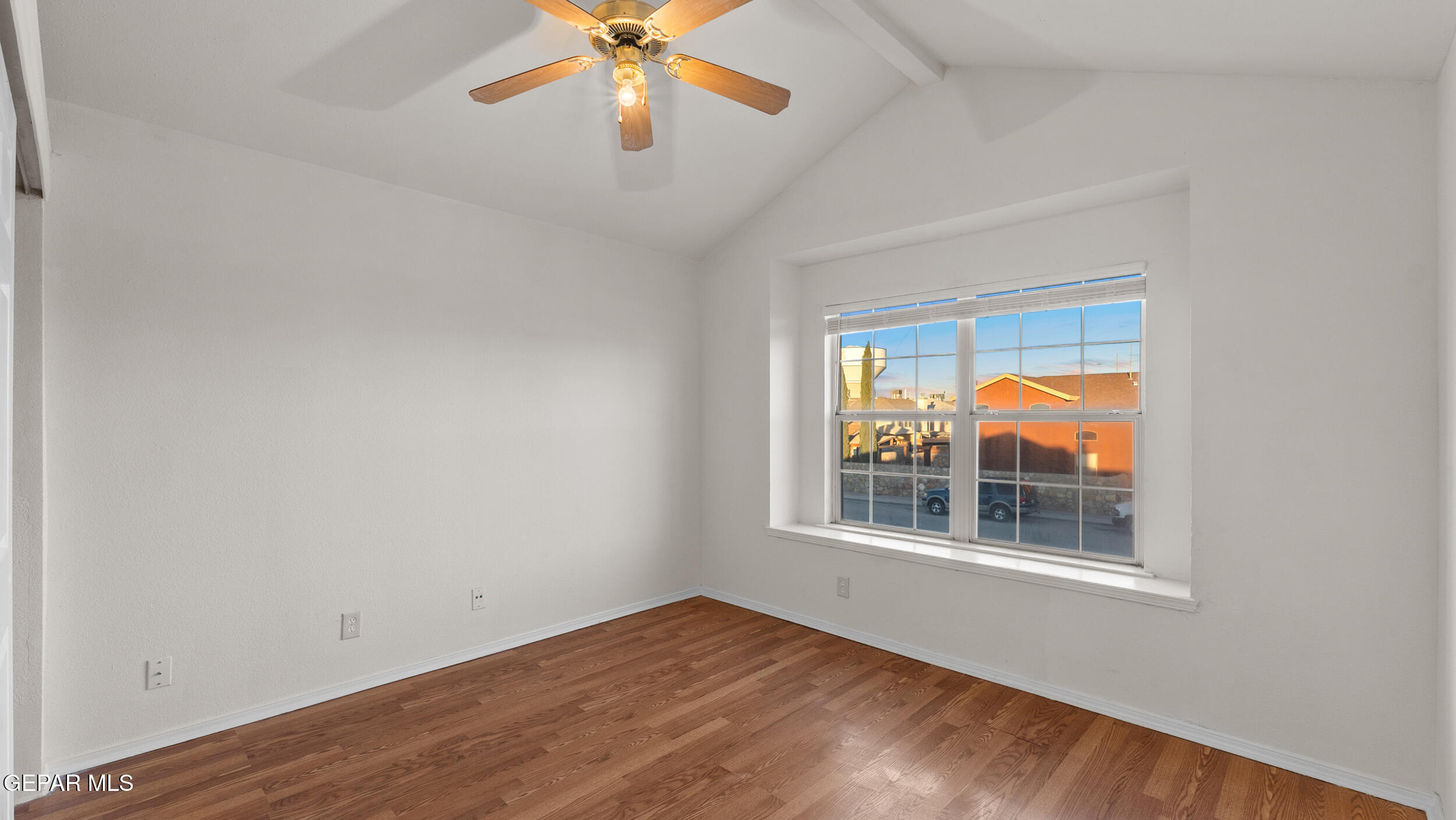 1729 St Mark Avenue El Paso, TX 79936 - Photo 18 of 31 a view of an empty room with window and wooden floor
