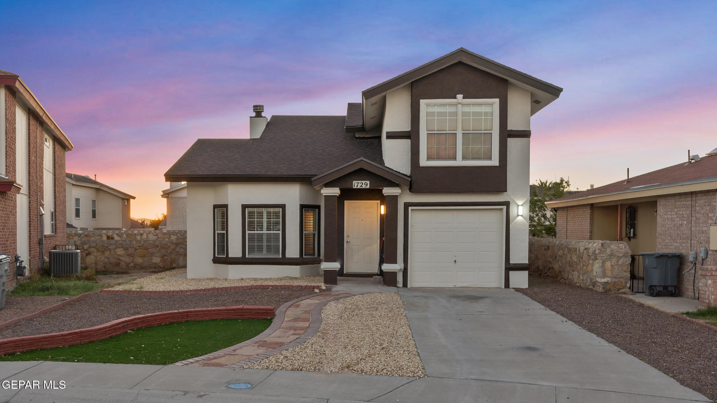 1729 St Mark Avenue El Paso, TX 79936 - Photo 2 of 31 a front view of a house with a yard and garage