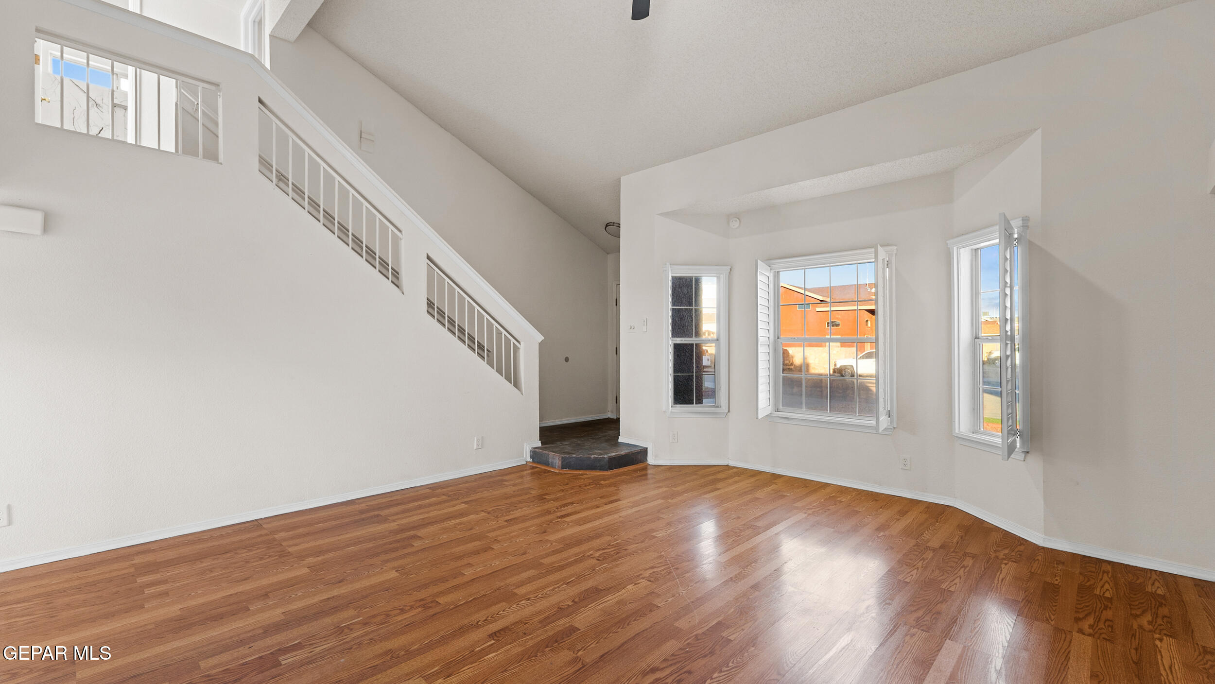 1729 St Mark Avenue El Paso, TX 79936 - Photo 7 of 31 a view of empty room with wooden floor and fan