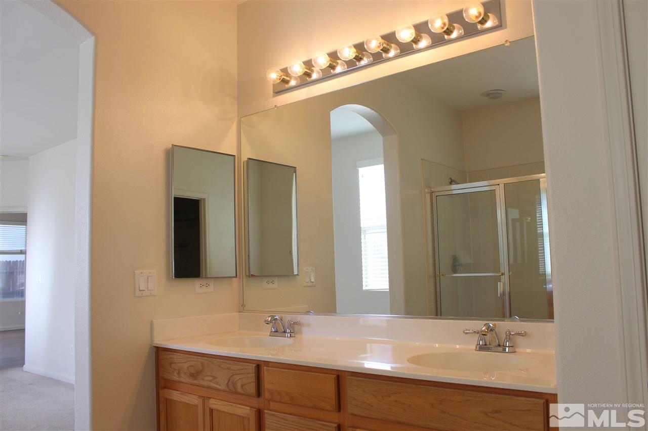 10409 Summershade Lane Reno, NV 89521 - Photo 8 of 22 a bathroom with a double vanity sink and a mirror
