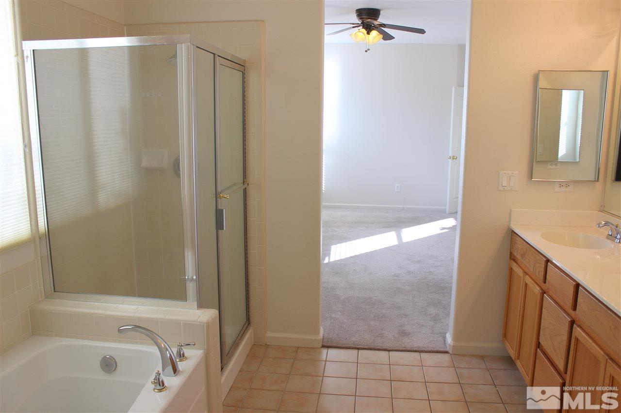 10409 Summershade Lane Reno, NV 89521 - Photo 9 of 22 a bathroom with a sink a toilet and shower