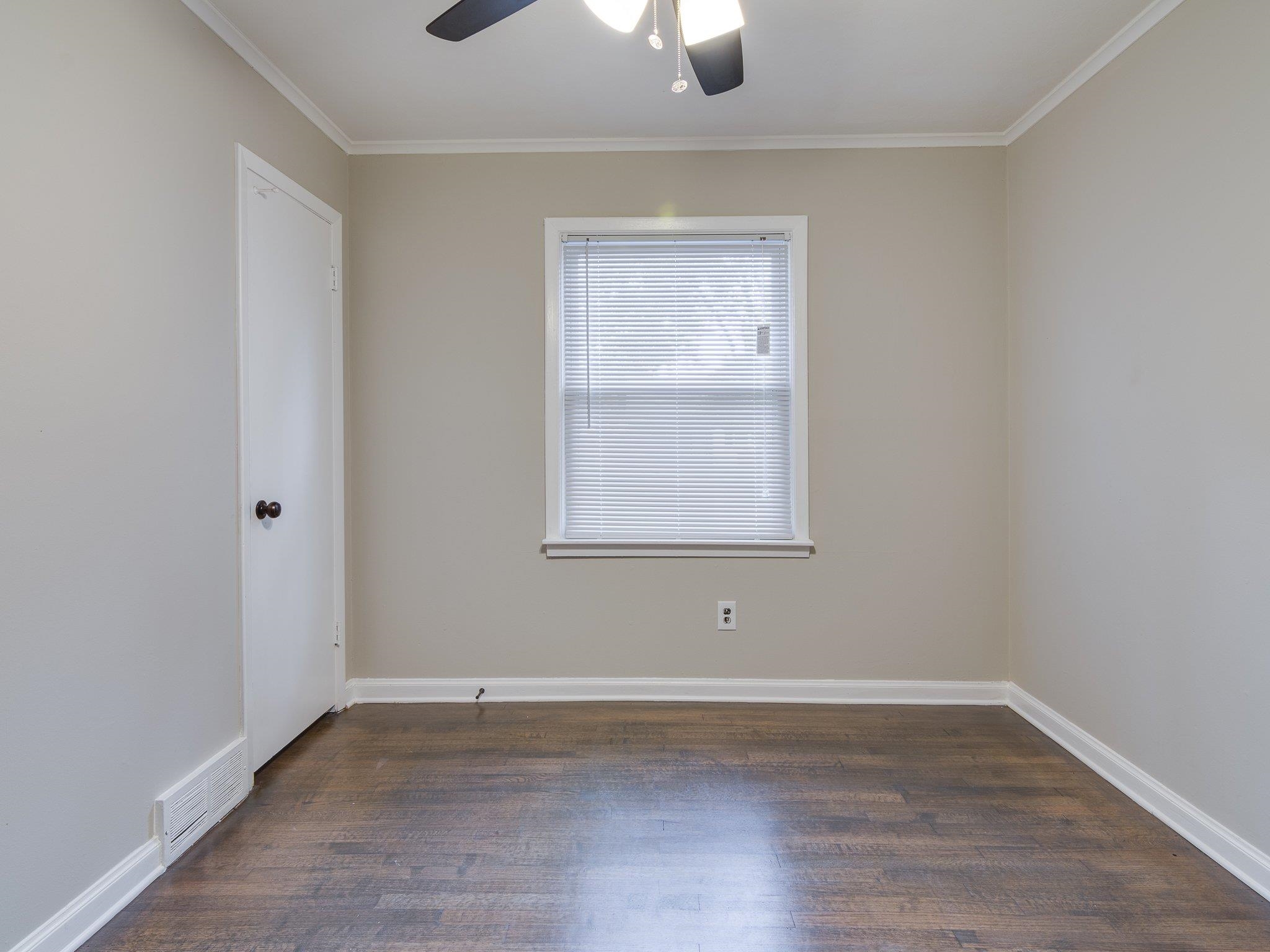 450 Homeville Road Collierville, TN 38017 - Photo 12 of 17 Unfurnished room with dark wood-type flooring, ceiling fan, and crown molding