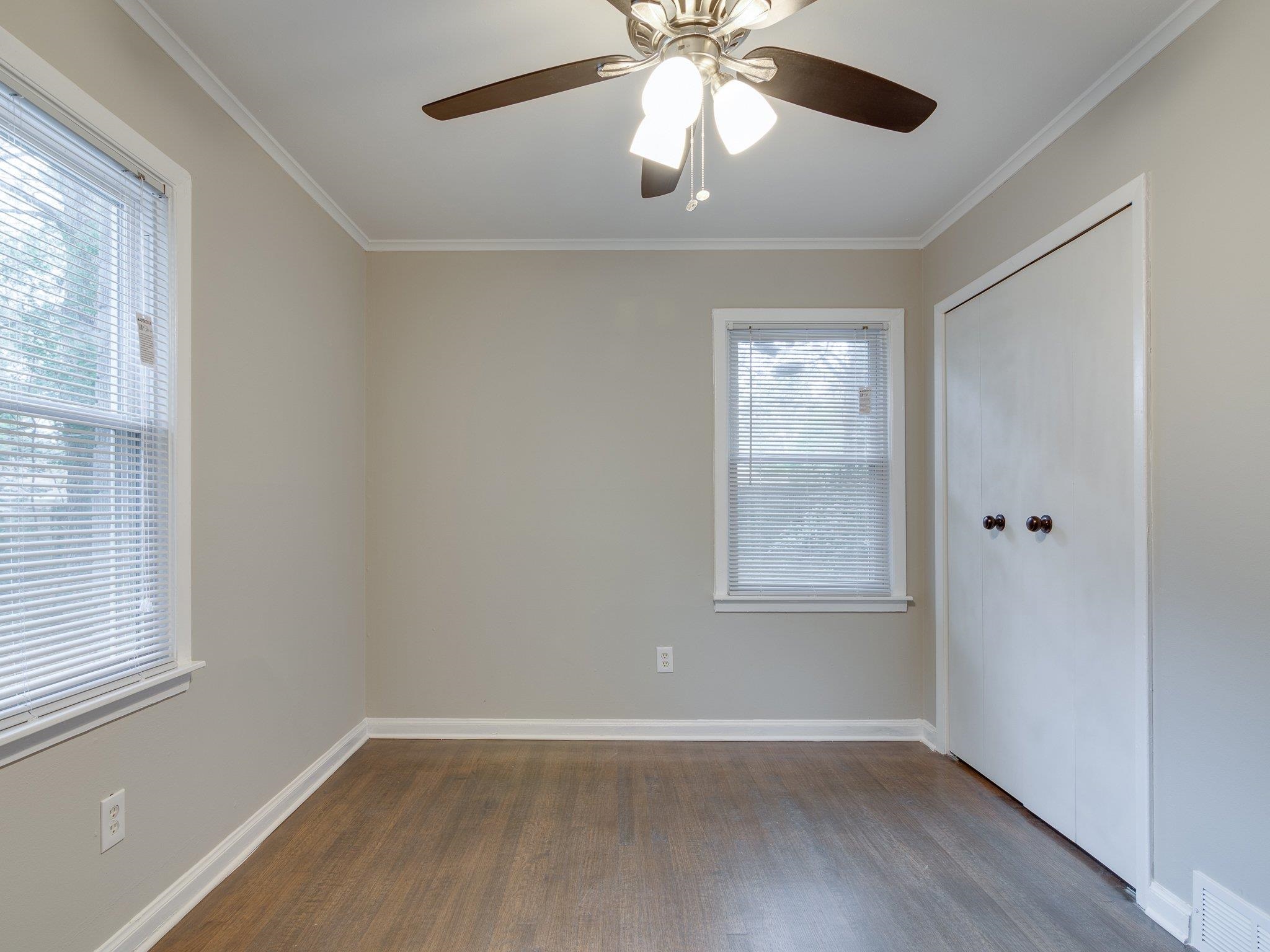 450 Homeville Road Collierville, TN 38017 - Photo 13 of 17 Spare room featuring ceiling fan, dark wood-type flooring, and crown molding