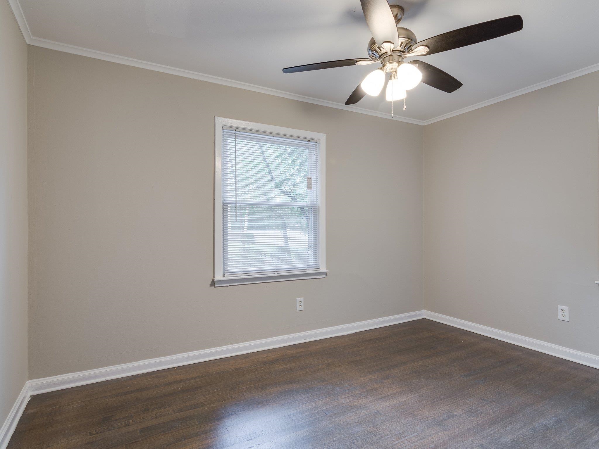 450 Homeville Road Collierville, TN 38017 - Photo 14 of 17 Unfurnished room with ornamental molding, dark wood-type flooring, and ceiling fan