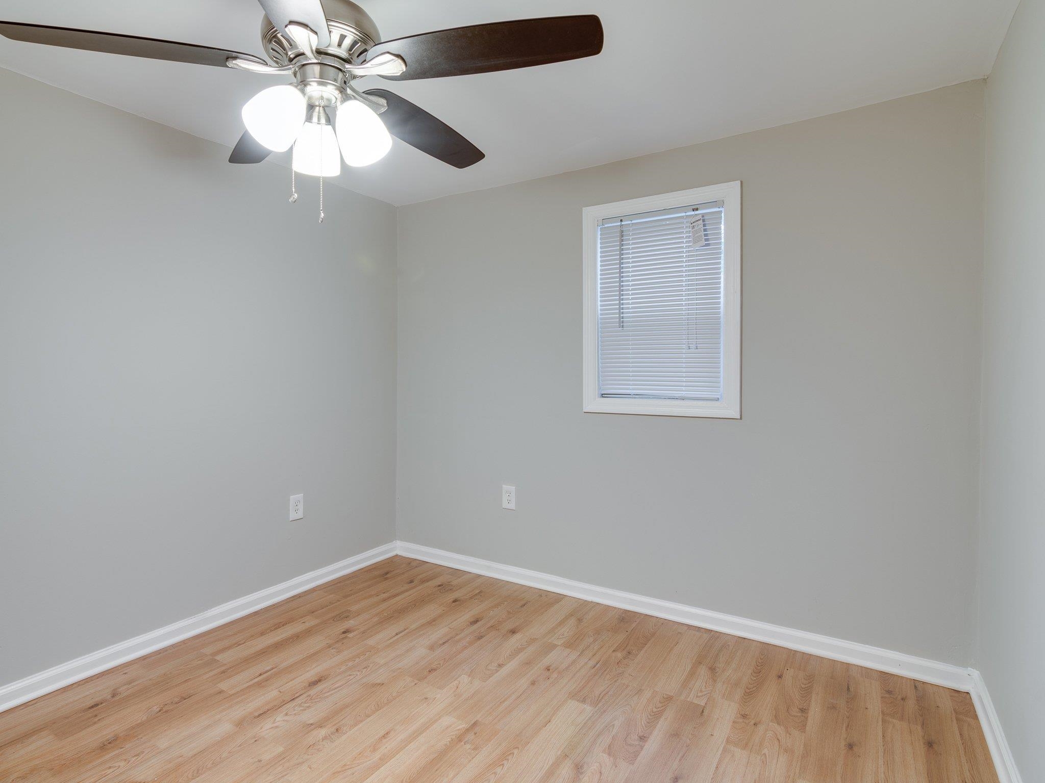 450 Homeville Road Collierville, TN 38017 - Photo 16 of 17 Unfurnished room with light wood-style floors and a ceiling fan