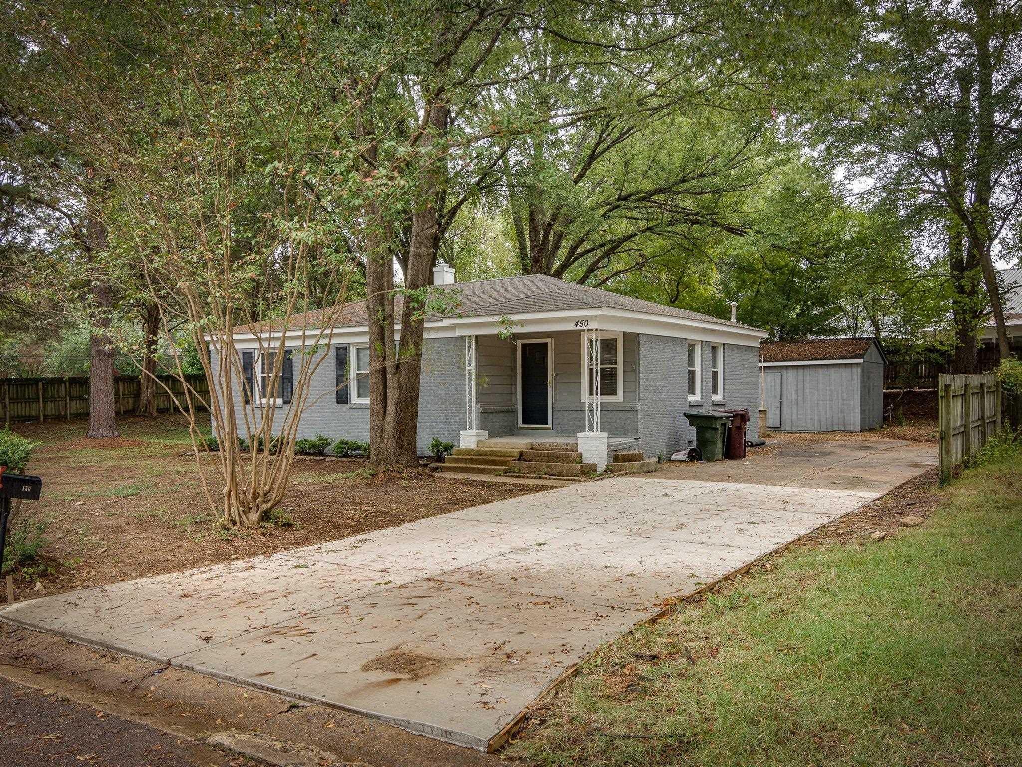 450 Homeville Road Collierville, TN 38017 - Photo 2 of 17 View of front of home with covered porch, brick siding, concrete driveway, and a shed