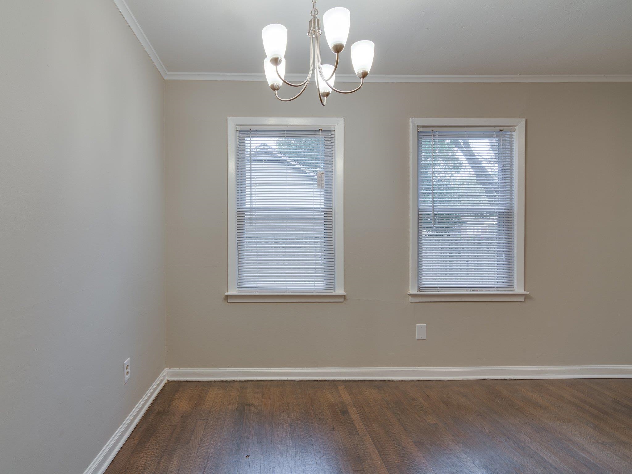 450 Homeville Road Collierville, TN 38017 - Photo 5 of 17 Unfurnished dining area featuring dark wood finished floors, a chandelier, and crown molding