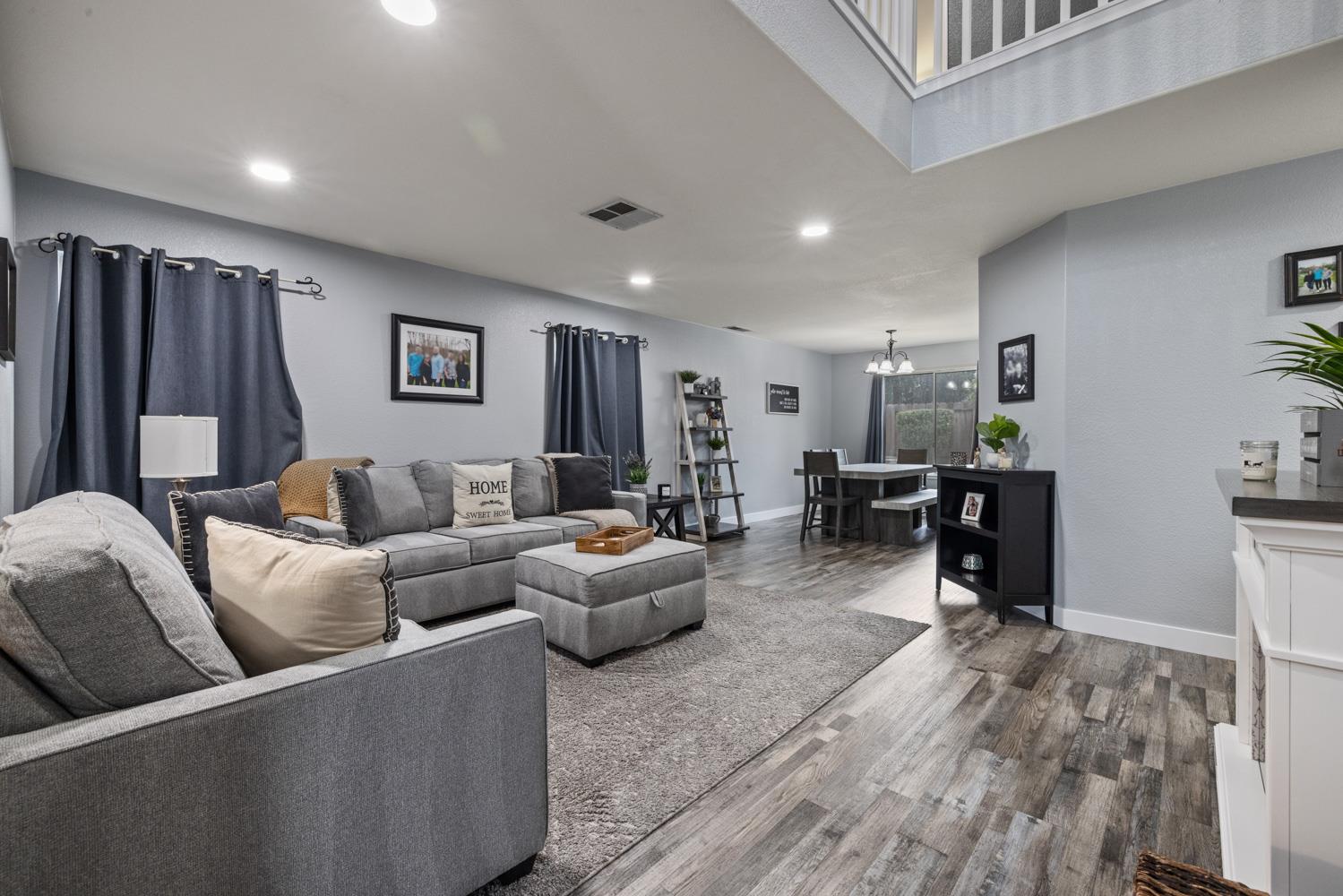818 Travaille Way Ripon, CA 95366 - Photo 12 of 52 a living room with furniture and wooden floor