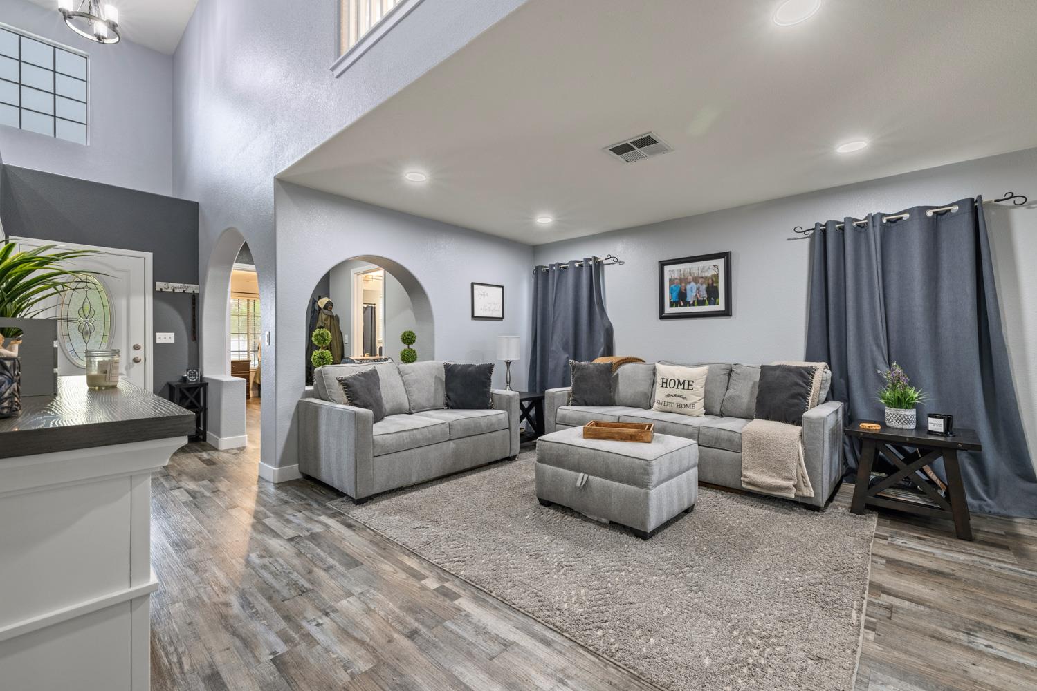 818 Travaille Way Ripon, CA 95366 - Photo 13 of 52 a living room with furniture a rug and a chandelier