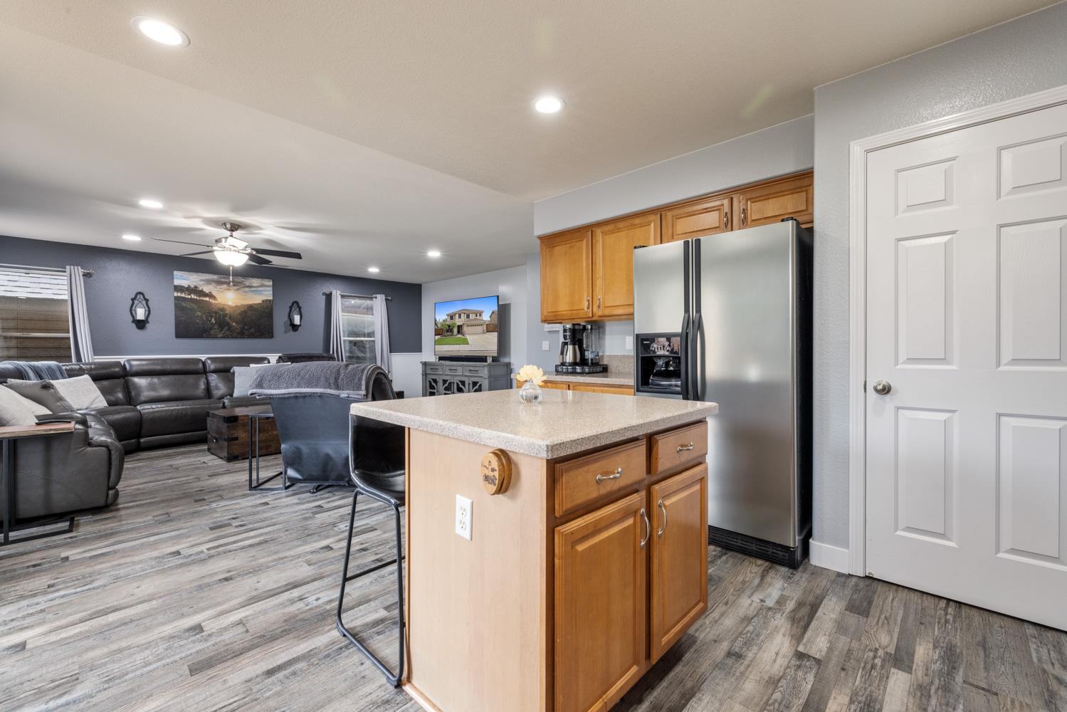 818 Travaille Way Ripon, CA 95366 - Photo 19 of 52 a kitchen with stainless steel appliances granite countertop a refrigerator a sink a stove and a wooden floors