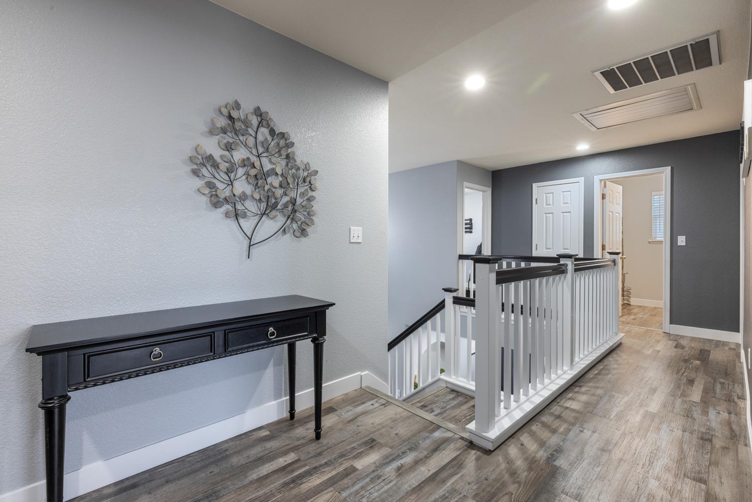 818 Travaille Way Ripon, CA 95366 - Photo 29 of 52 a view of a hallway with wooden floor and staircase